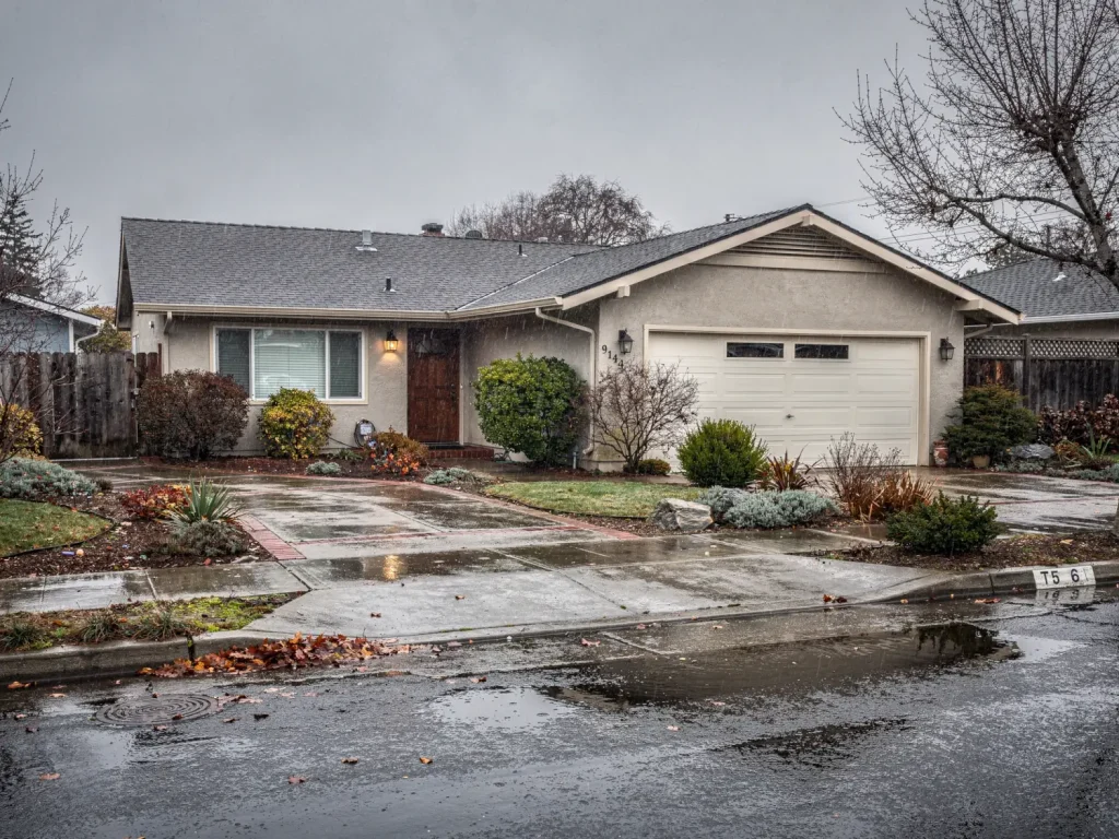 Bay Area home in rainy winter weather showing conditions that can complicate exterior painting
