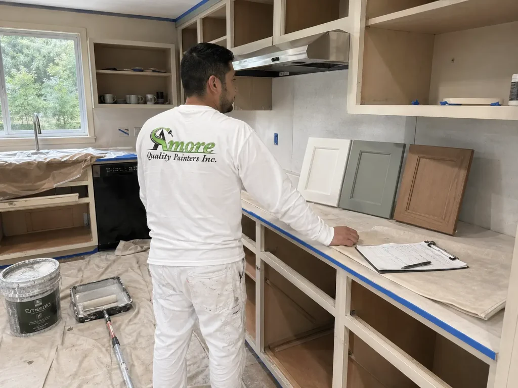 Amore Painters professional reviewing cabinet color samples and solid cabinet boxes before a kitchen cabinet painting project.