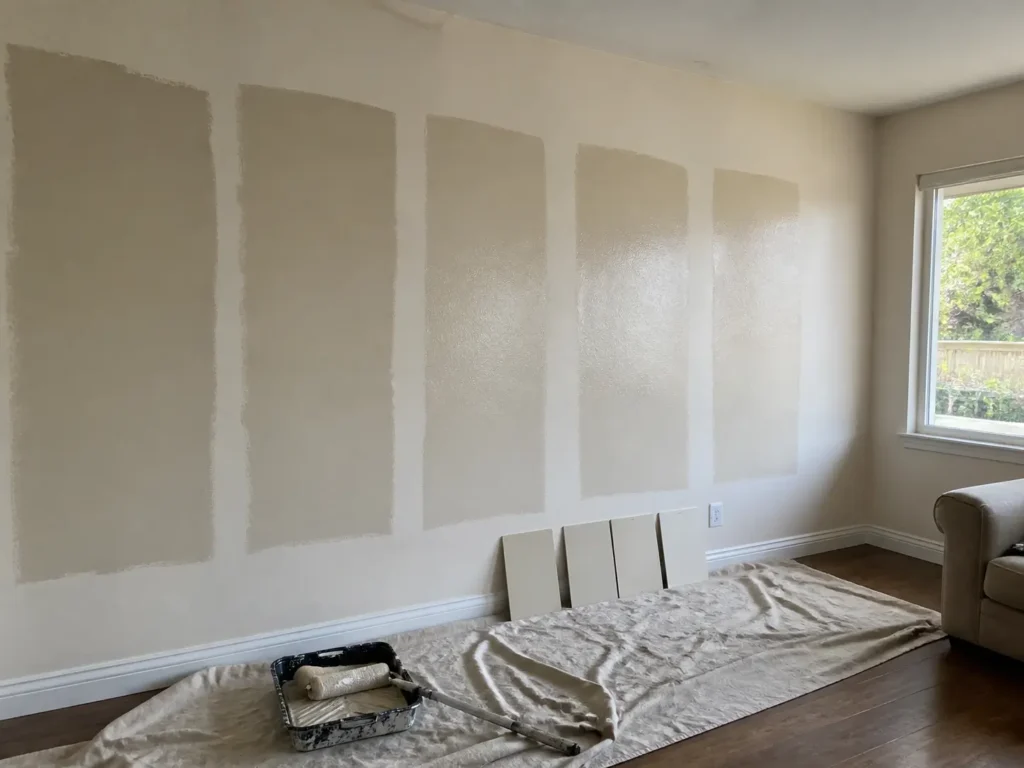 Five wall paint samples show flat, matte, eggshell, satin, and glossier finishes in natural window light.